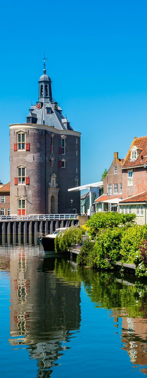 Historic waterfront with tower and houses