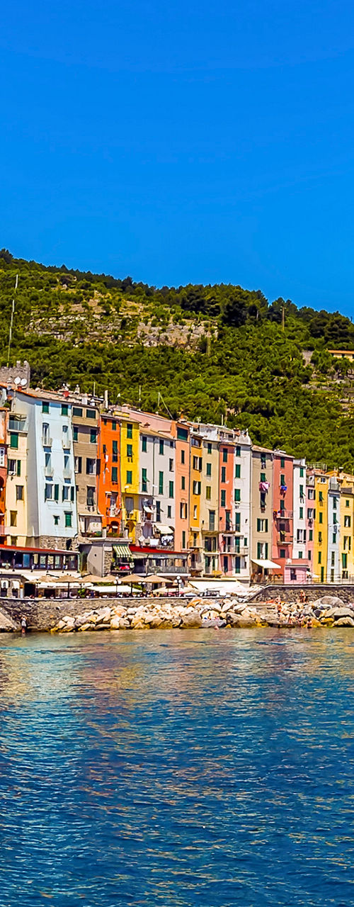 Colorful seaside village with hillside backdrop