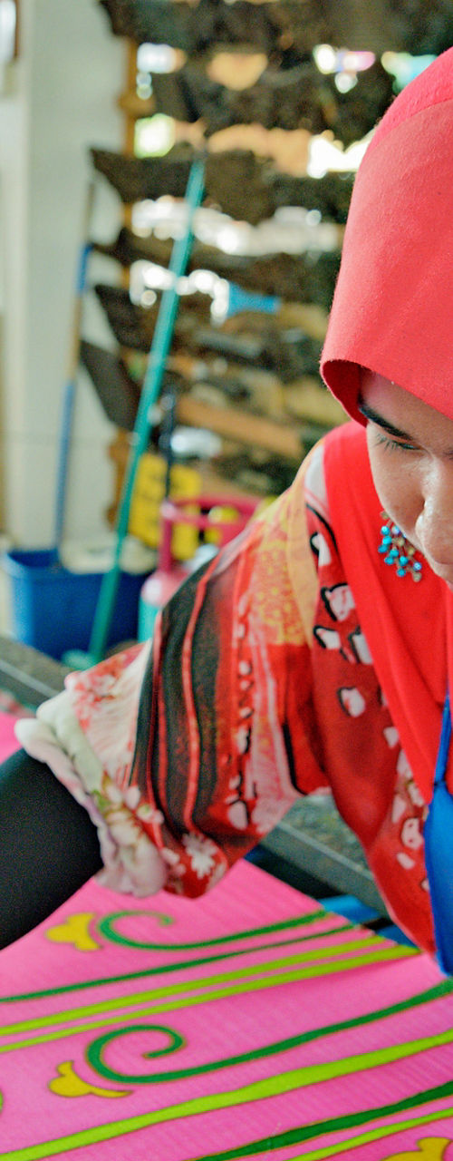 Artisan painting vibrant textile design