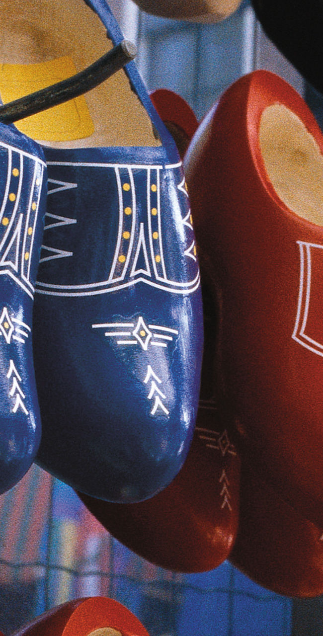 Colorful wooden clogs on display rack