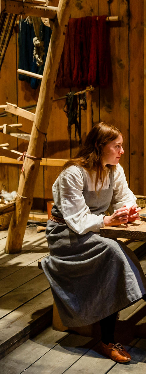 Historical reenactment in rustic wooden cabin