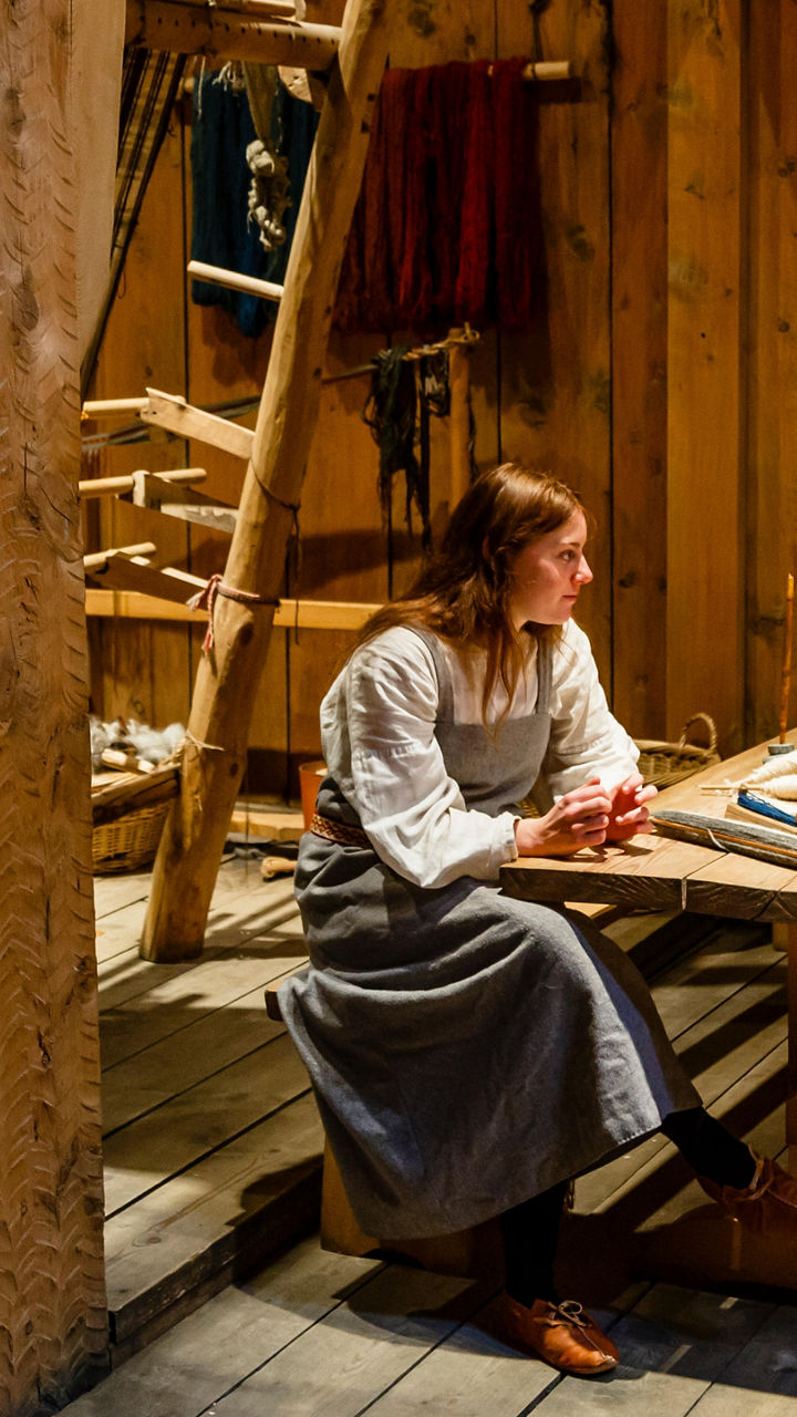 Historical reenactment in rustic wooden cabin