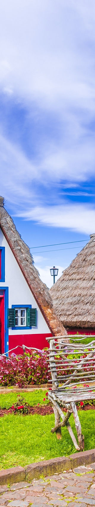 Traditional A-frame cottages in lush garden