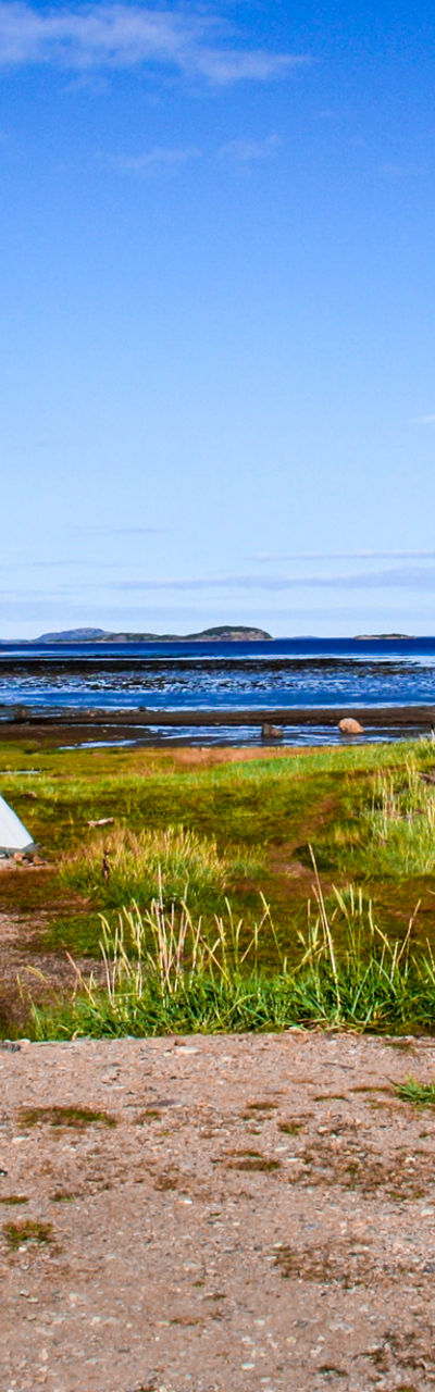 Teepees by a serene lakeside view