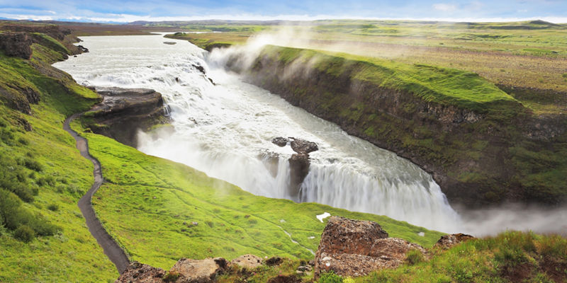 Majestic waterfall in lush green valley