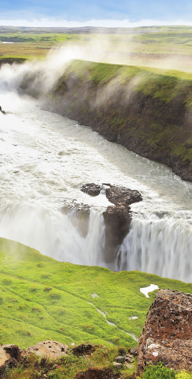 Majestic waterfall in lush green valley