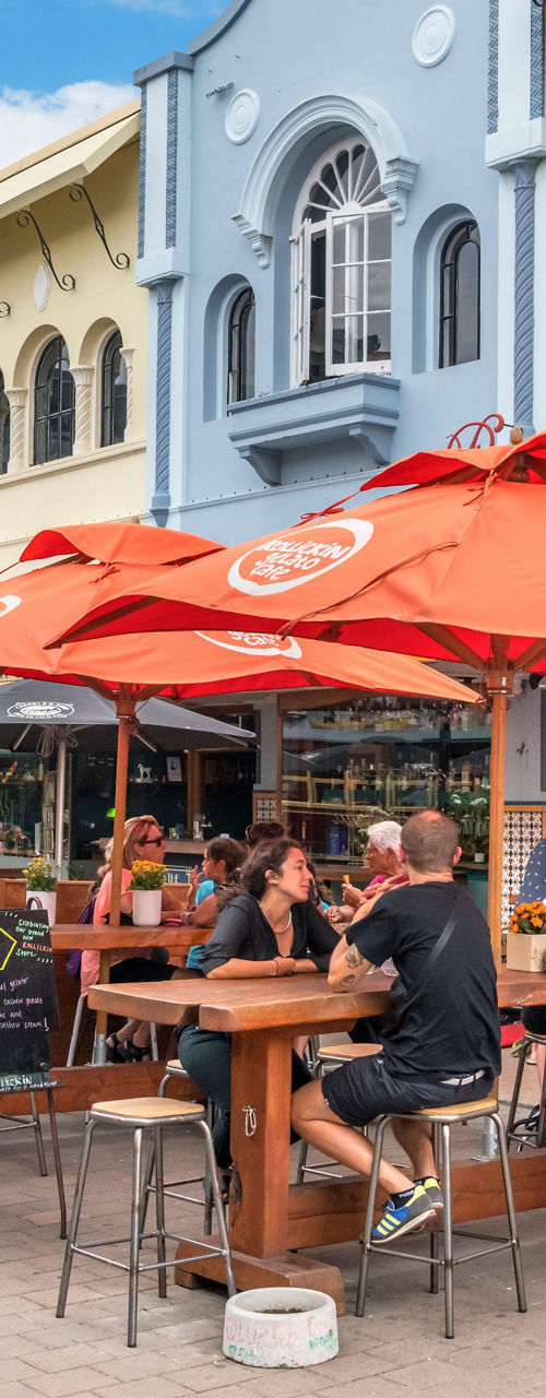Historic tram passing vibrant outdoor café scene