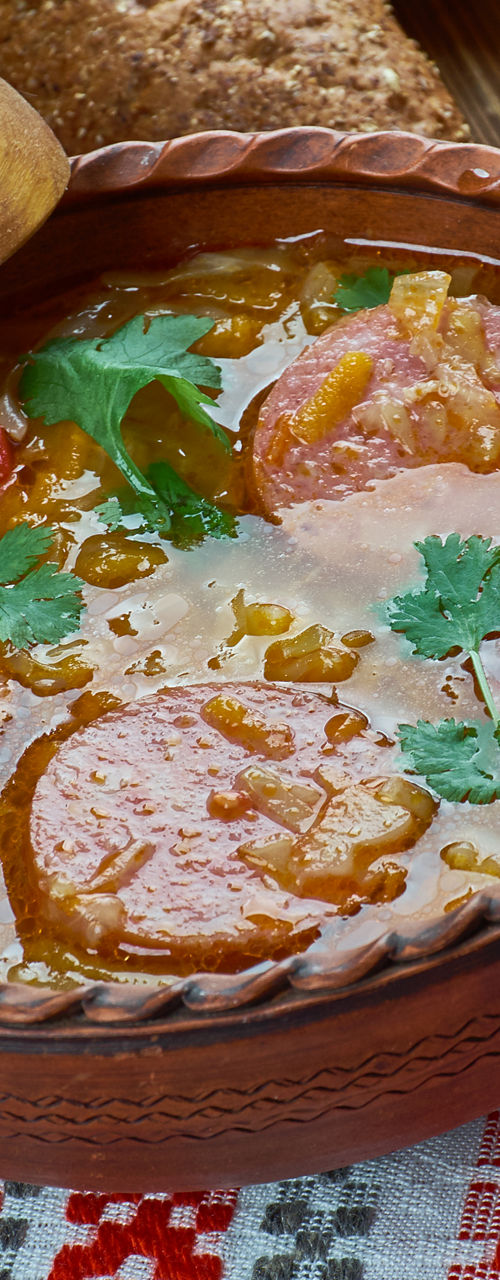 Traditional soup in rustic ceramic bowl