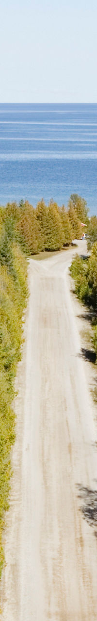 Scenic forest road leading to blue lake