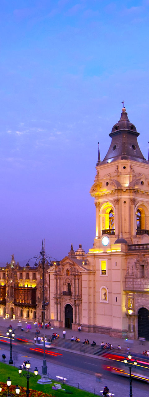 Historic cathedral in vibrant cityscape at dusk