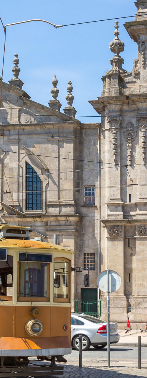 Historic tram passing ornate church facade