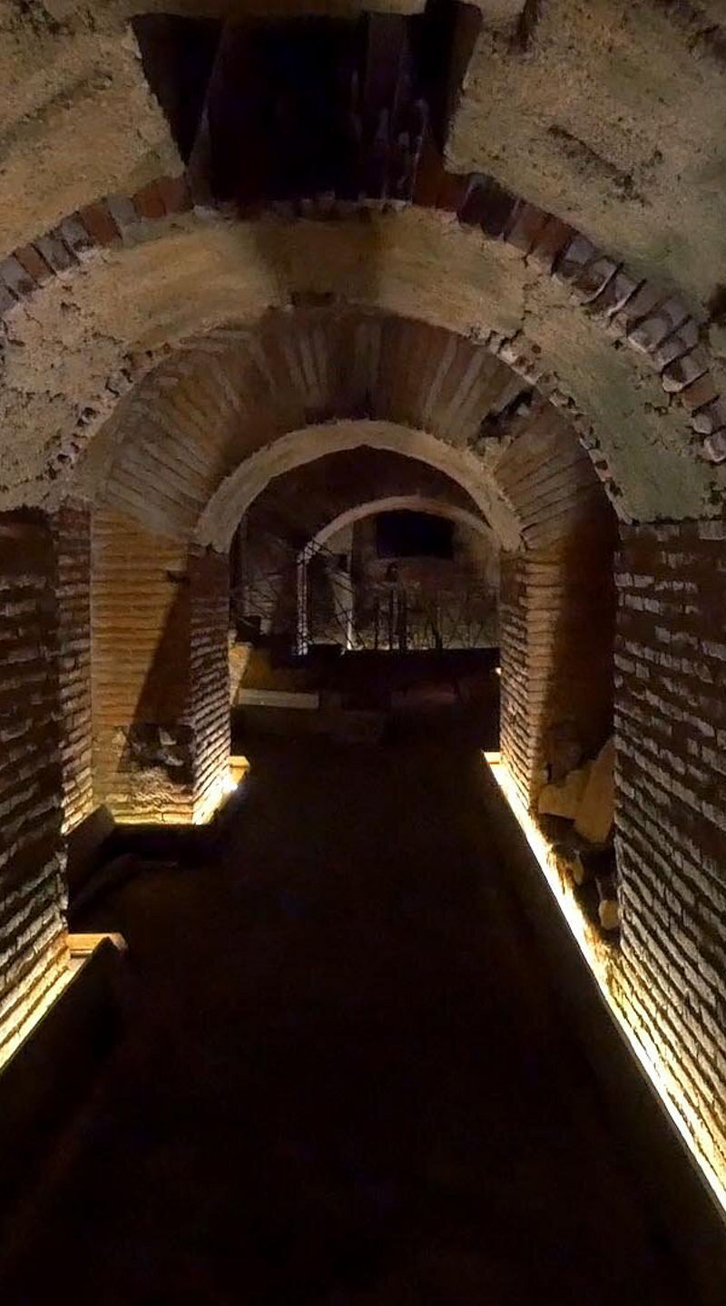 Illuminated ancient brick tunnel interior