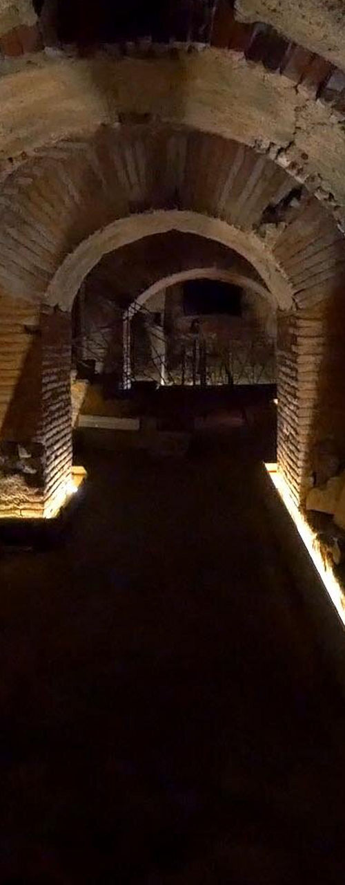 Illuminated ancient brick tunnel interior