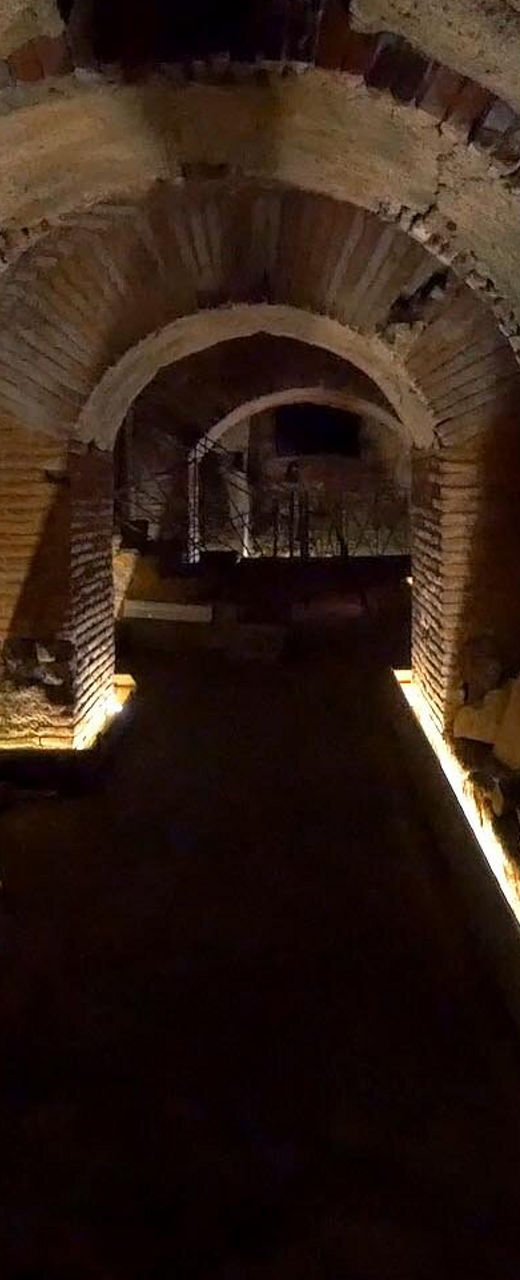 Illuminated ancient brick tunnel interior