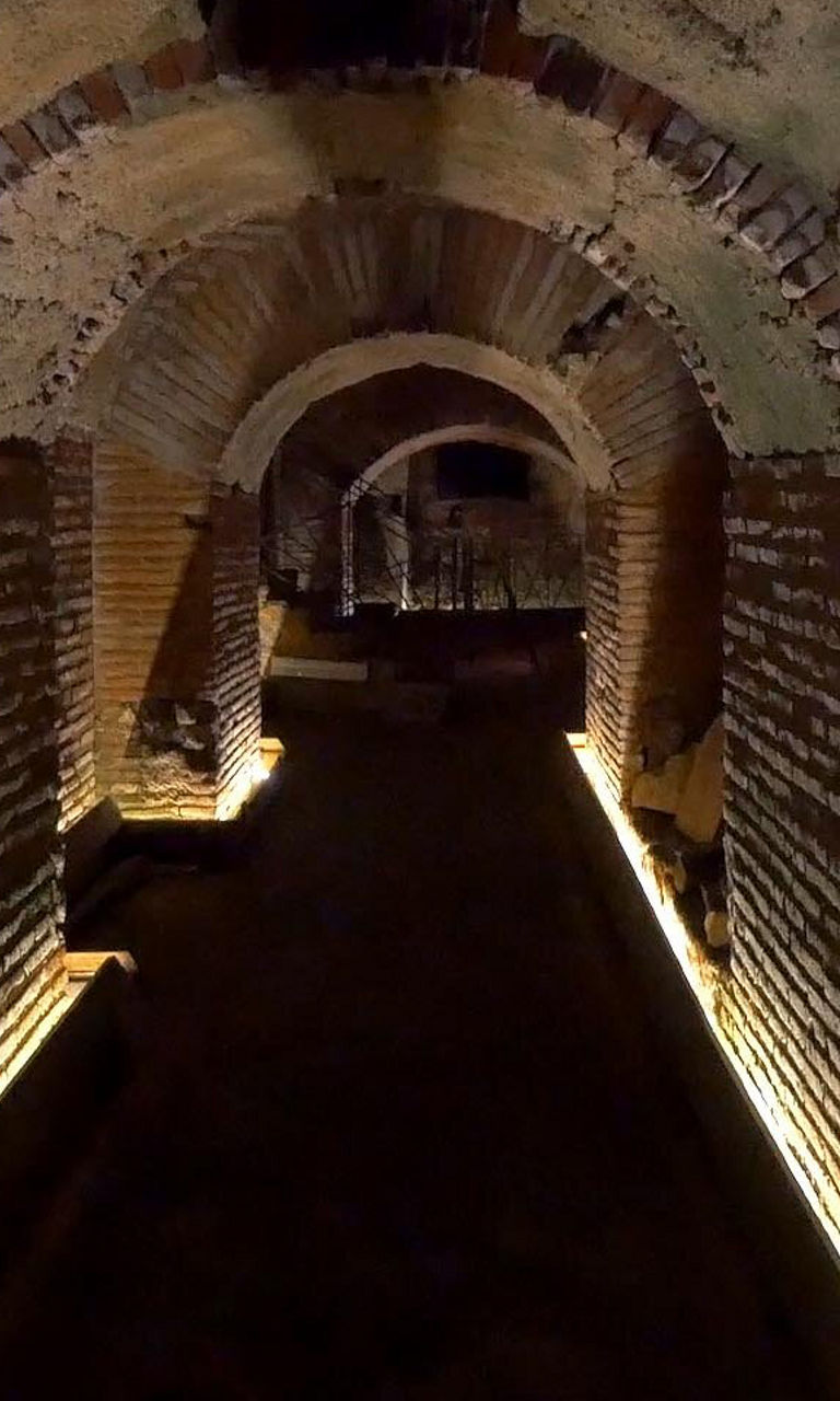 Illuminated ancient brick tunnel interior