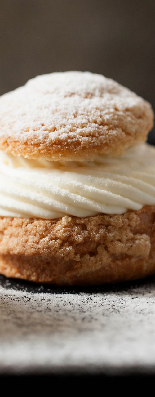 Cream-filled pastries dusted with powdered sugar