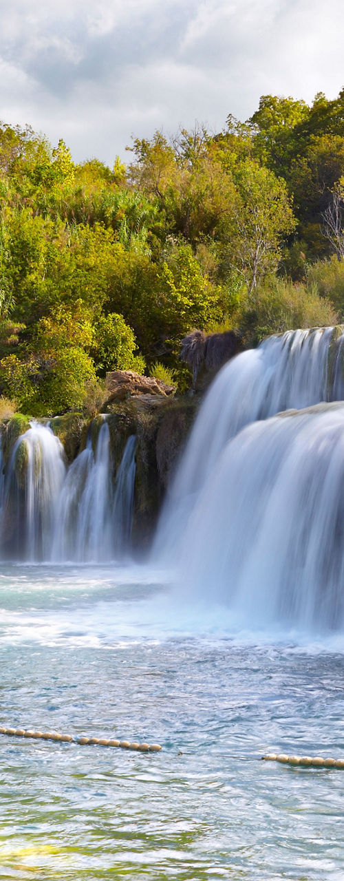 Scenic waterfall surrounded by lush greenery