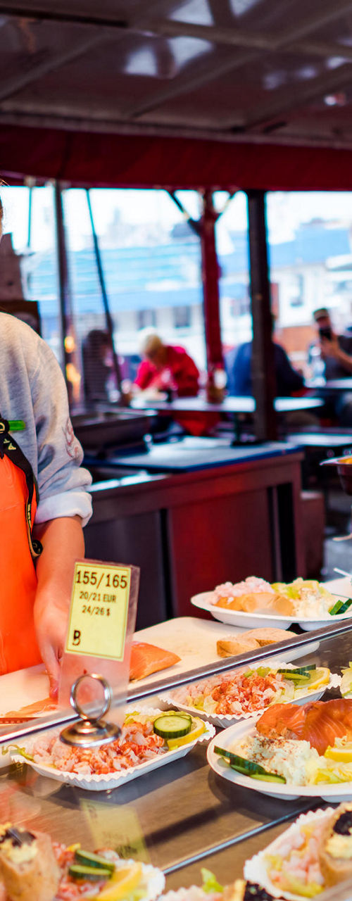 Seafood vendor at outdoor market stall