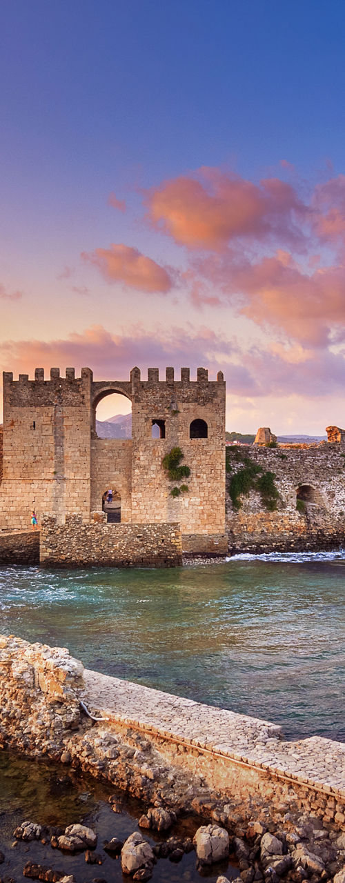 Historic seaside castle at sunset