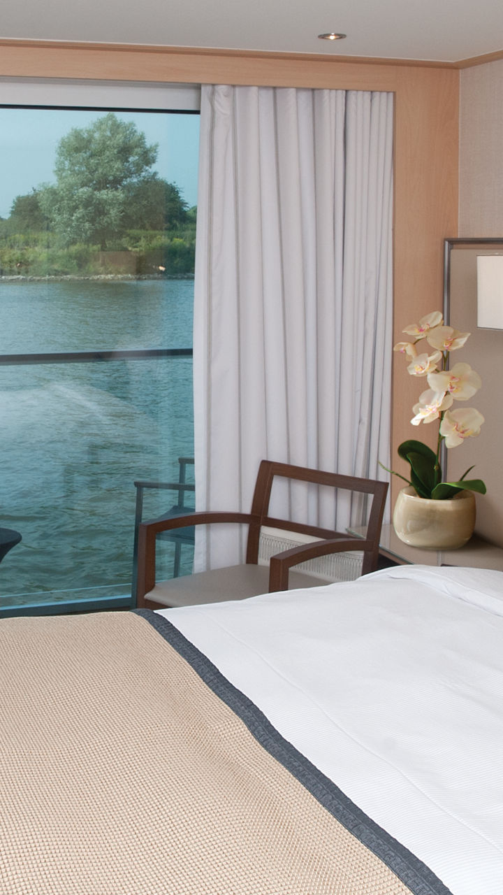 Modern riverfront hotel room with balcony view
