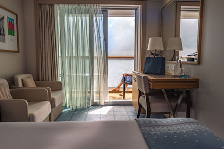 Cozy cruise cabin with balcony view