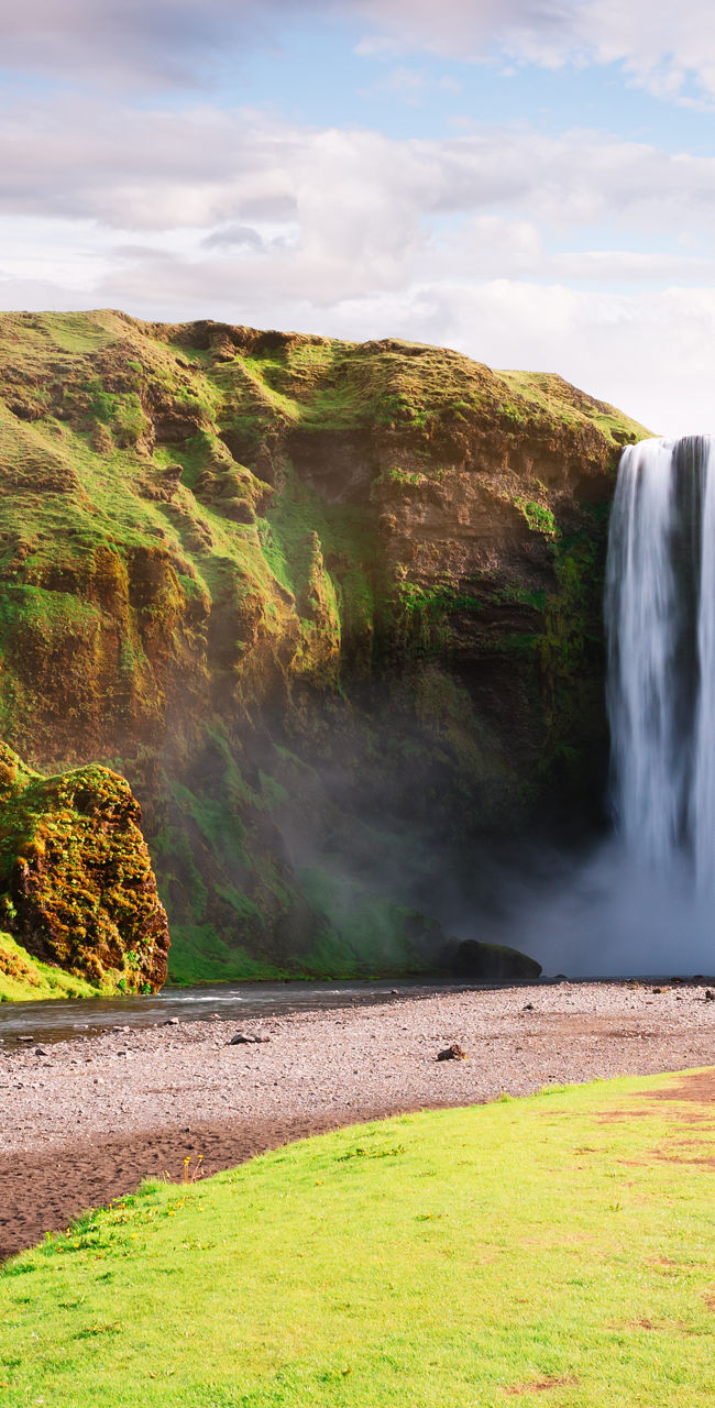 Scenic waterfall in lush green landscape