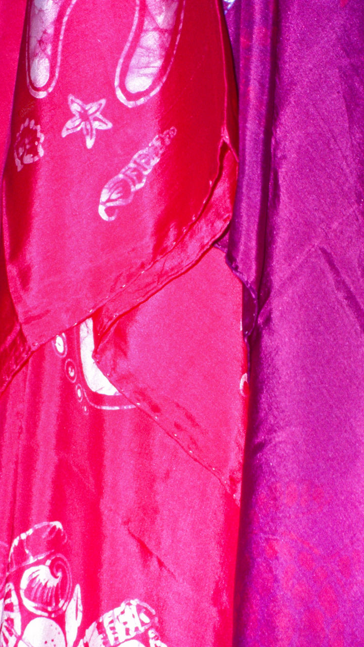 Colorful patterned fabrics hanging in display