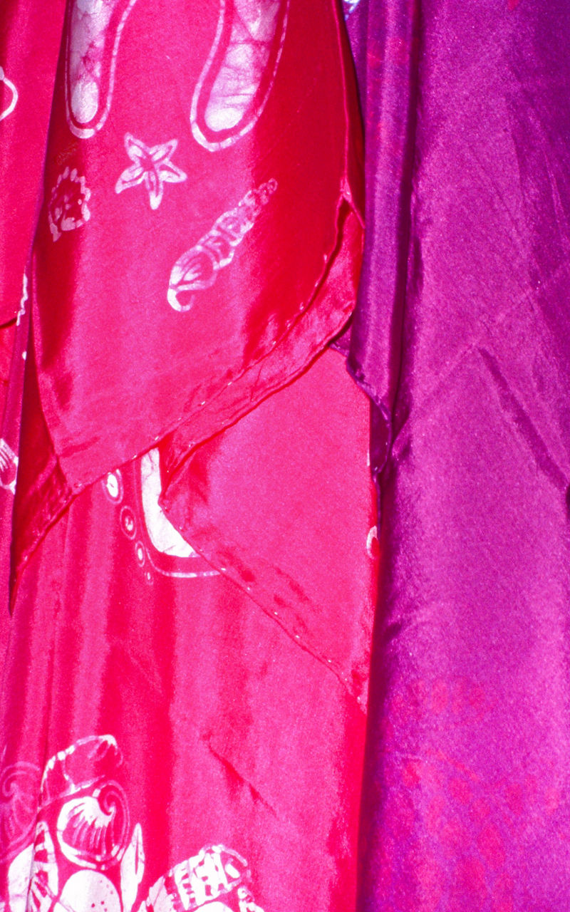Colorful patterned fabrics hanging in display