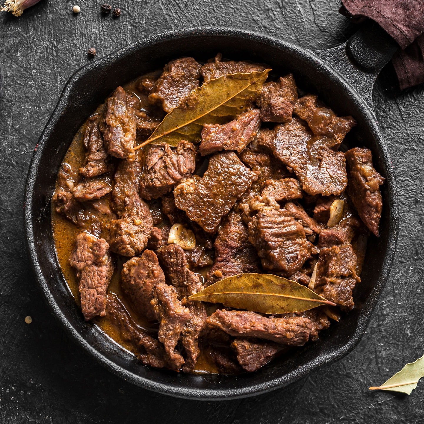 Braised beef stew in cast iron skillet