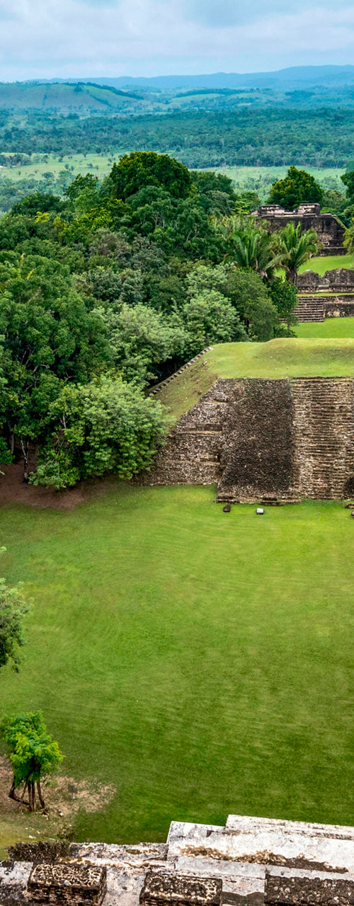 Ancient Mayan ruins in lush landscape