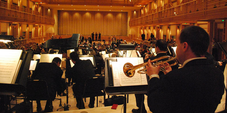 Orchestra performing in grand concert hall
