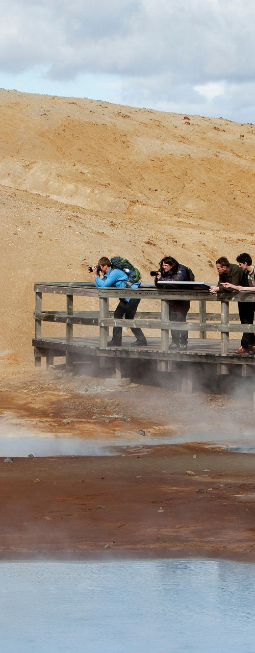 Tourists observing geothermal hot spring