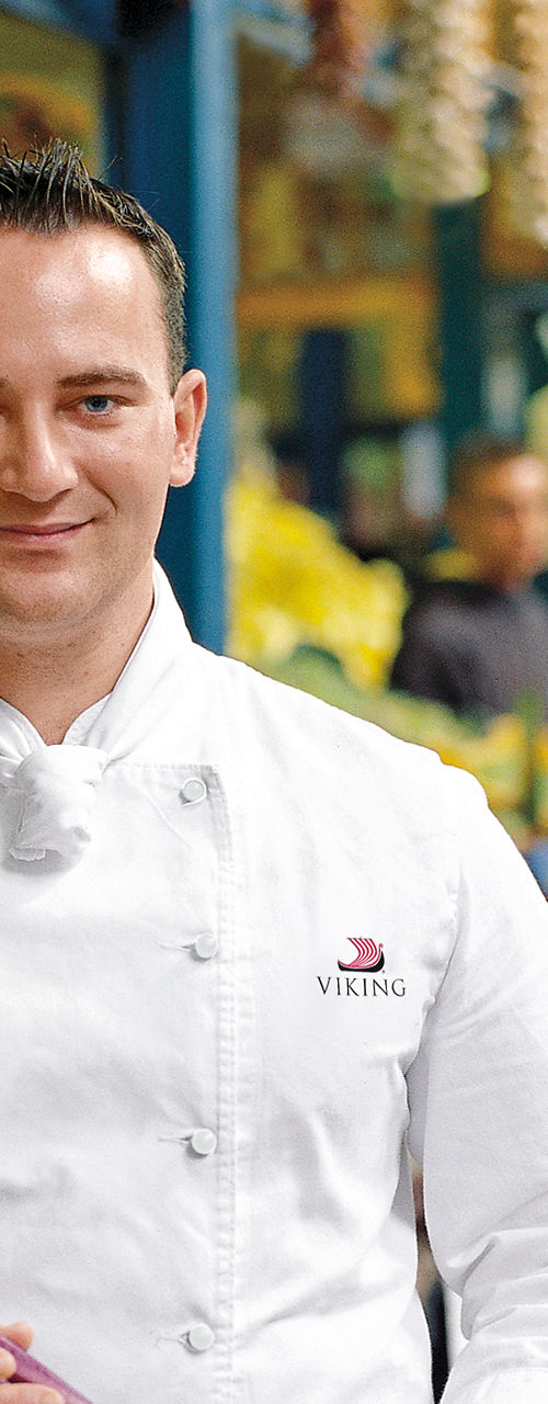Chef holding fresh vegetables at market
