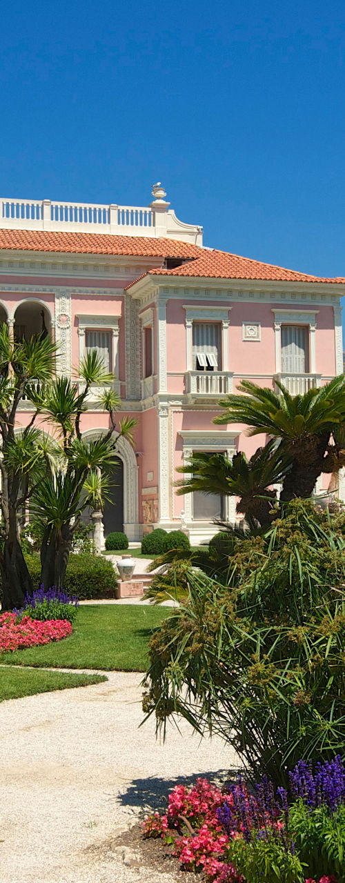 Elegant pink villa with lush gardens
