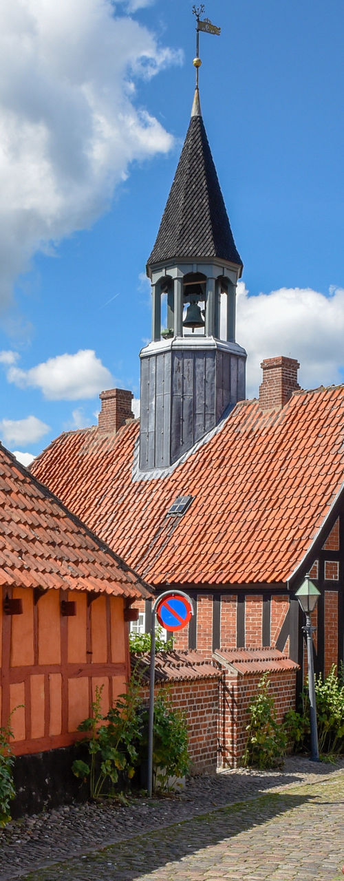 Historic cobblestone street with half-timbered houses