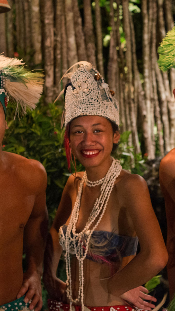 Traditional dancers in tropical setting at night