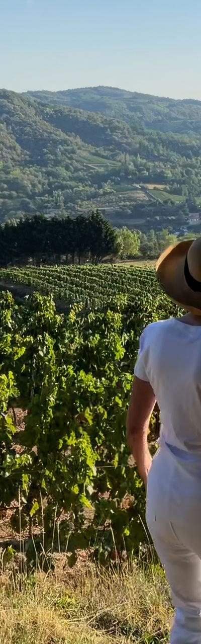 Woman in vineyard overlooking scenic hills
