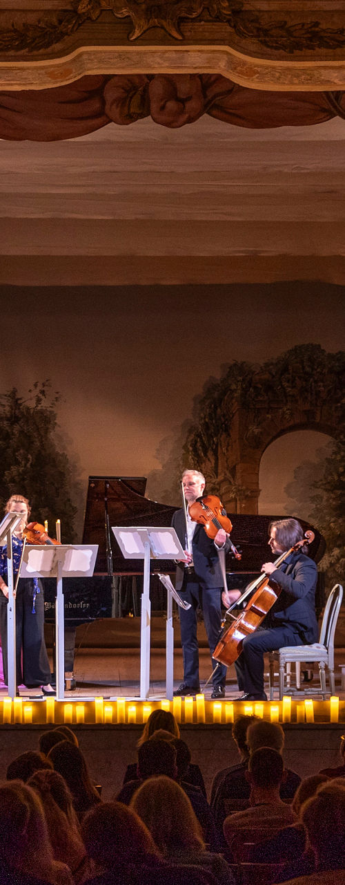 Classical quartet performing in candlelit theater