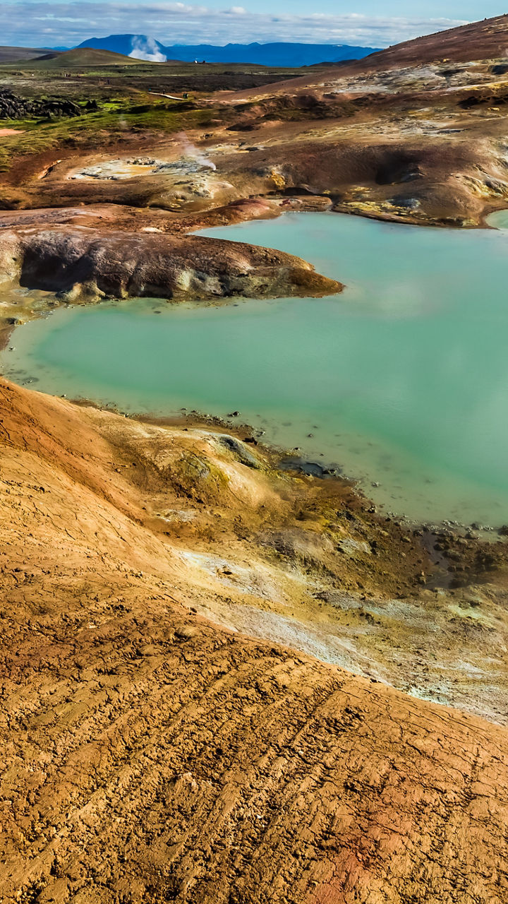 Geothermal landscape with steaming hot springs