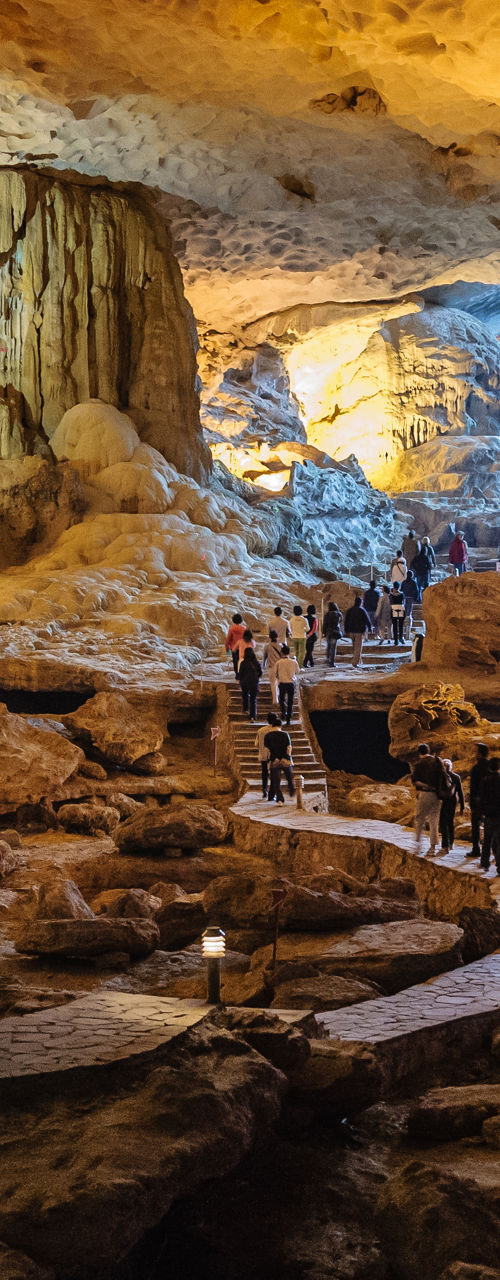 Illuminated limestone cave with walking path