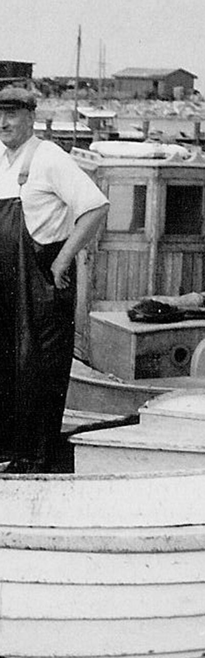 Vintage fishing boat with two fishermen