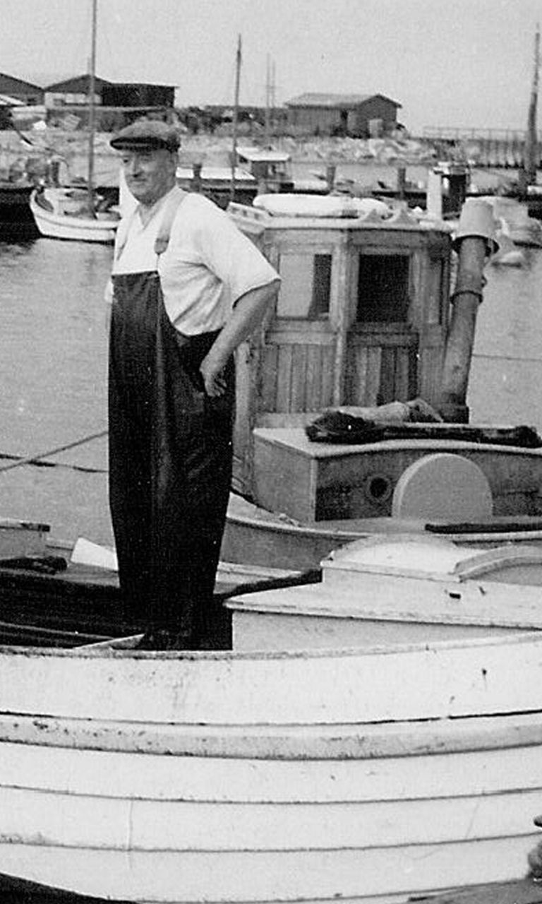 Vintage fishing boat with two fishermen