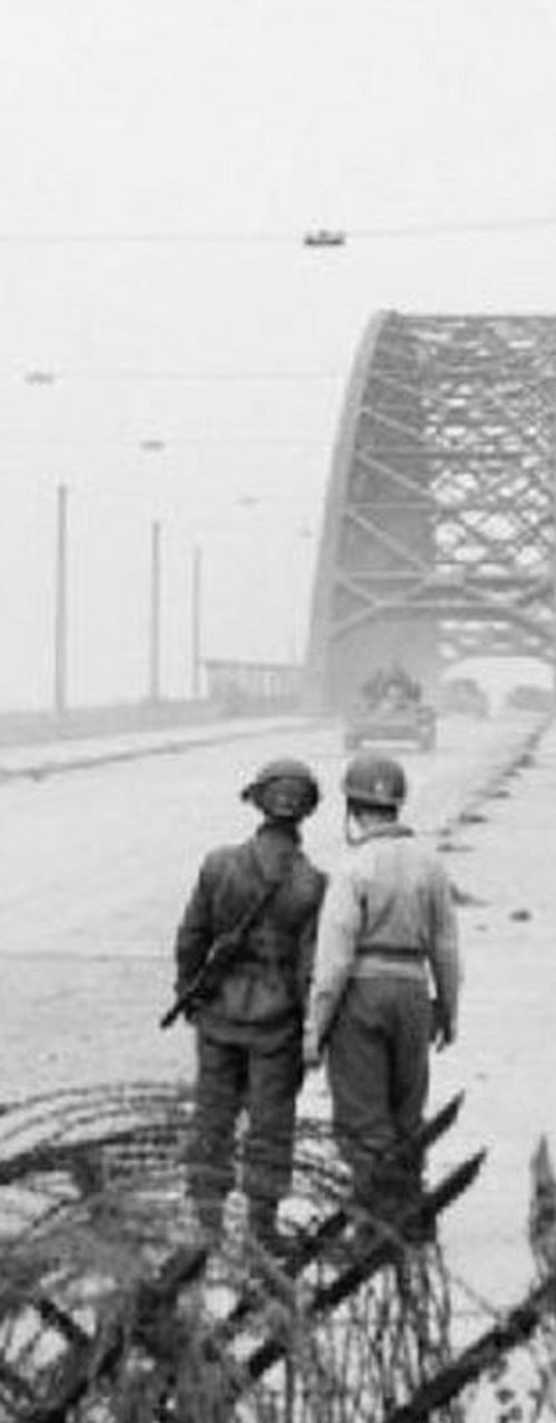 Soldiers and tanks on bridge during wartime