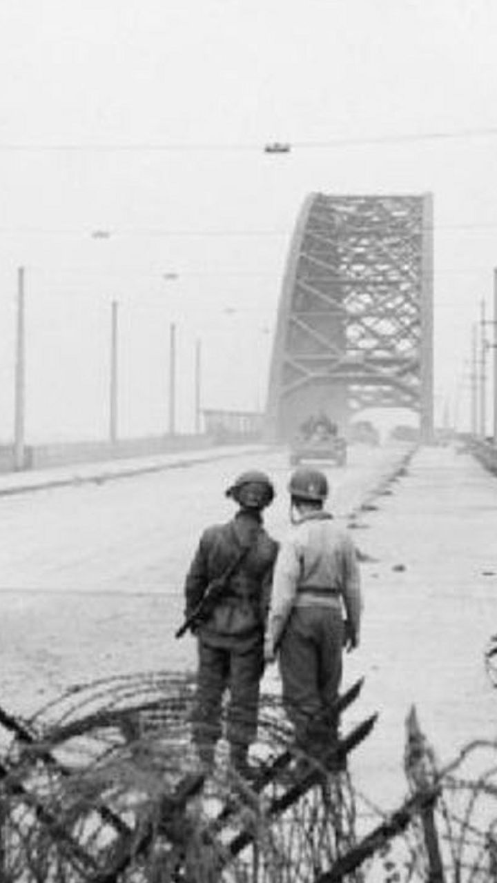Soldiers and tanks on bridge during wartime
