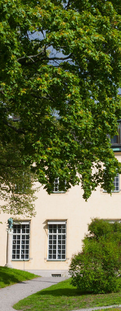 Historic building surrounded by lush greenery