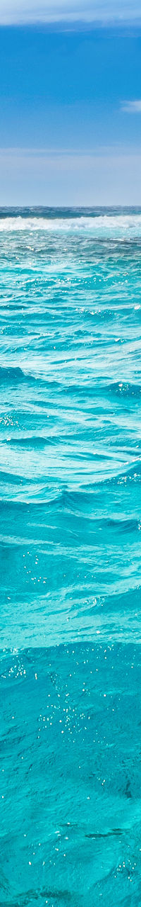 Vast turquoise ocean under blue sky