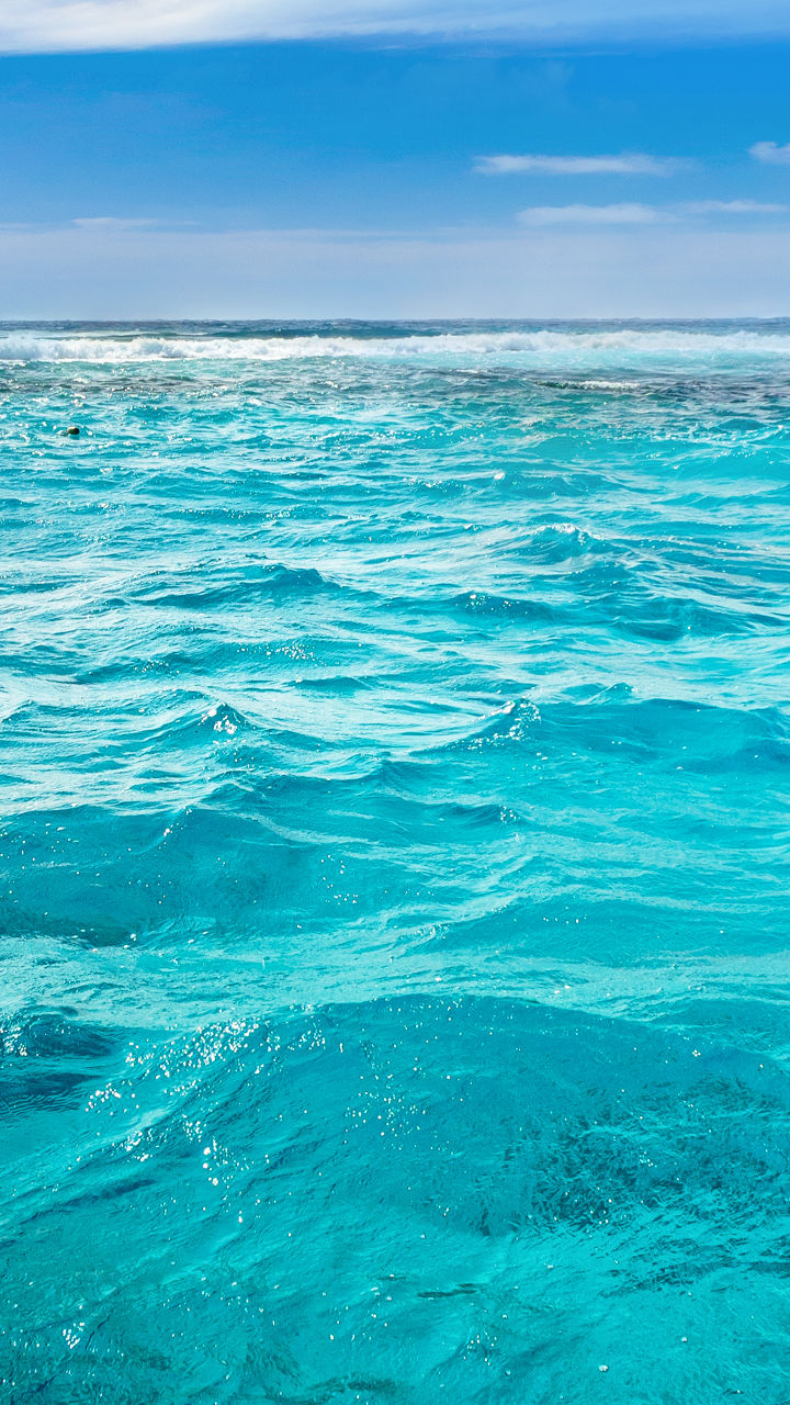 Vast turquoise ocean under blue sky