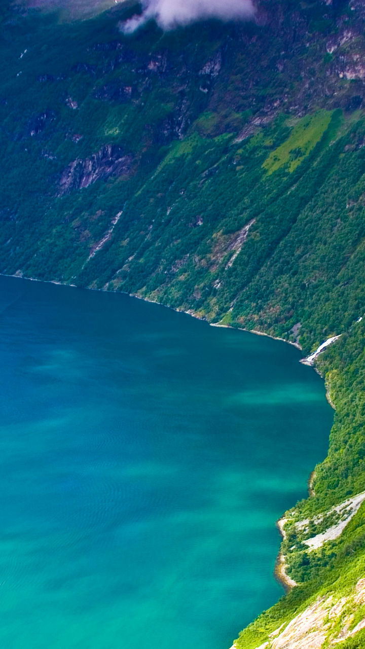 Scenic fjord with waterfall and lush greenery