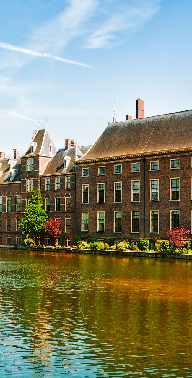 Historic building by serene waterfront