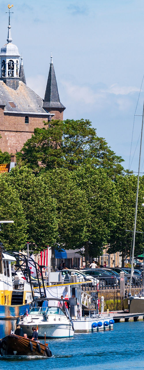 Scenic harbor with boats and historic tower